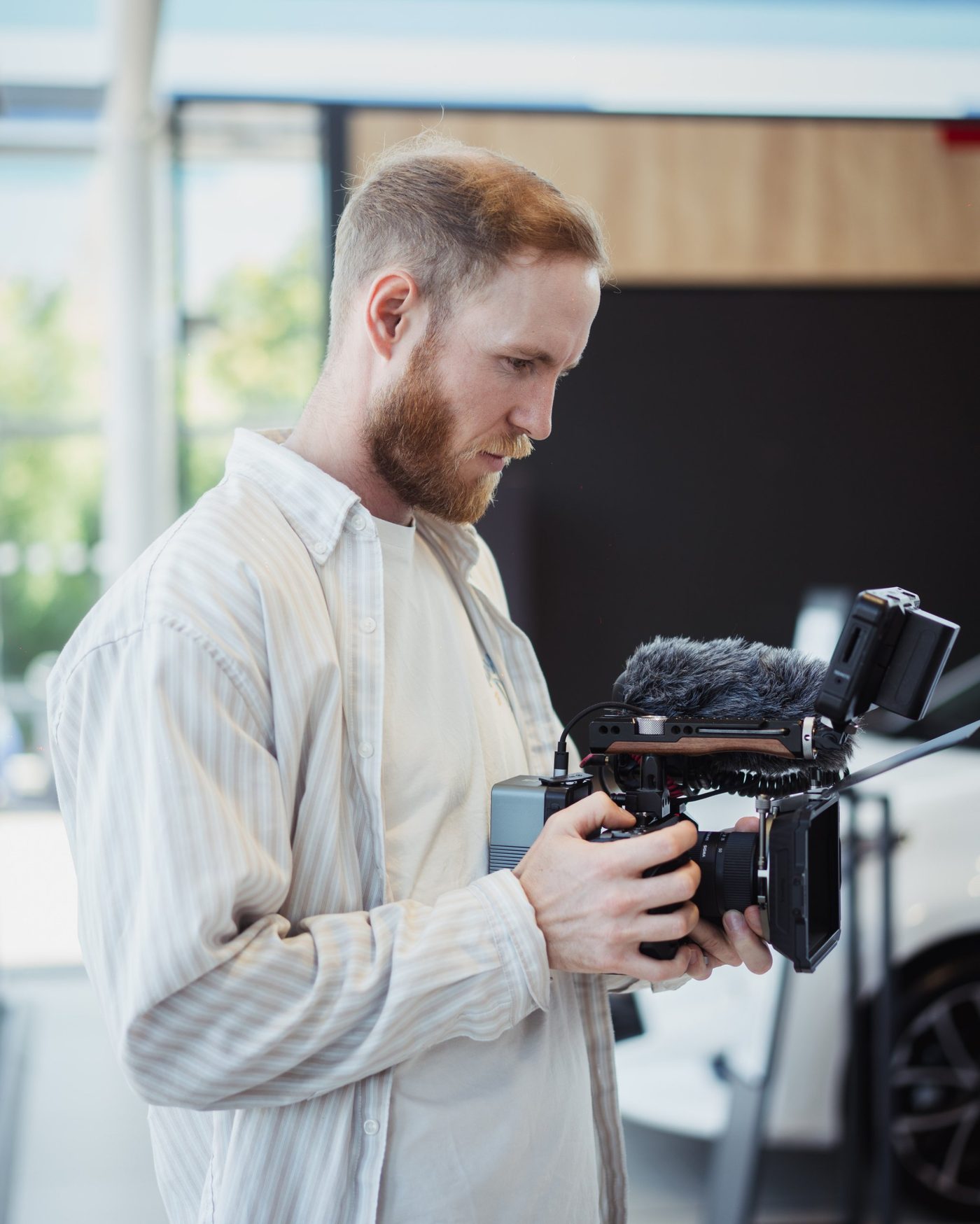 Keegan Starkey holding a cinema camera on location